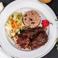 Jerk Chicken Meal · Jamaican jerk style chicken with rice and peas and steamed cabbage.