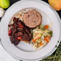 Brown Stew Chicken · Jamaican style chicken using special browning seasoning with rice and peas and steamed cabba...