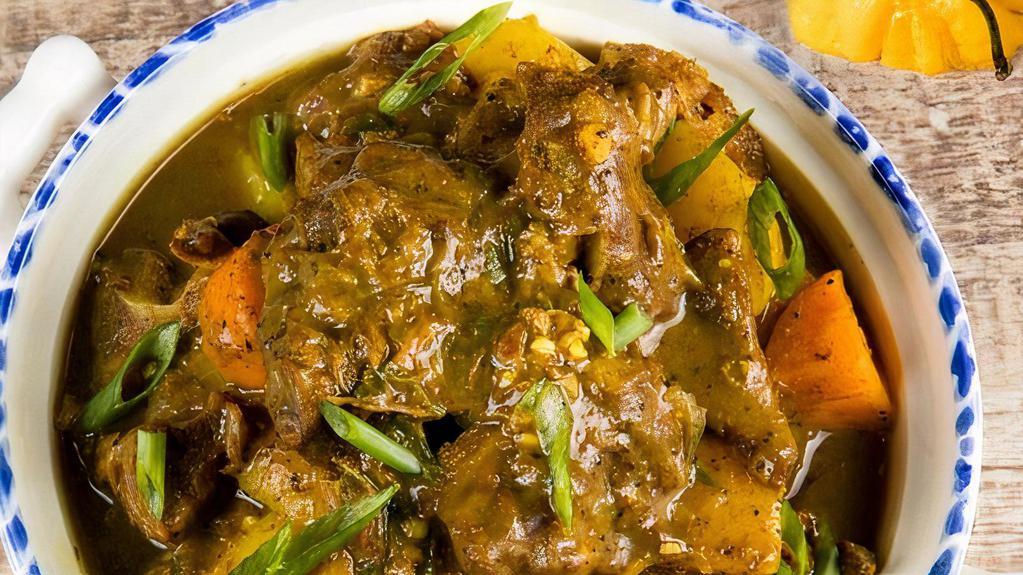 Curry Goat · A traditional Jamaican dish in which goat meat is infused with the flavours of curry powder, chopped onion, escallion, garlic, ginger, thyme and spices.