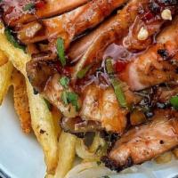 Jerk Chicken And Fries  · Jamaican style Jerk chicken with a side of French fries.