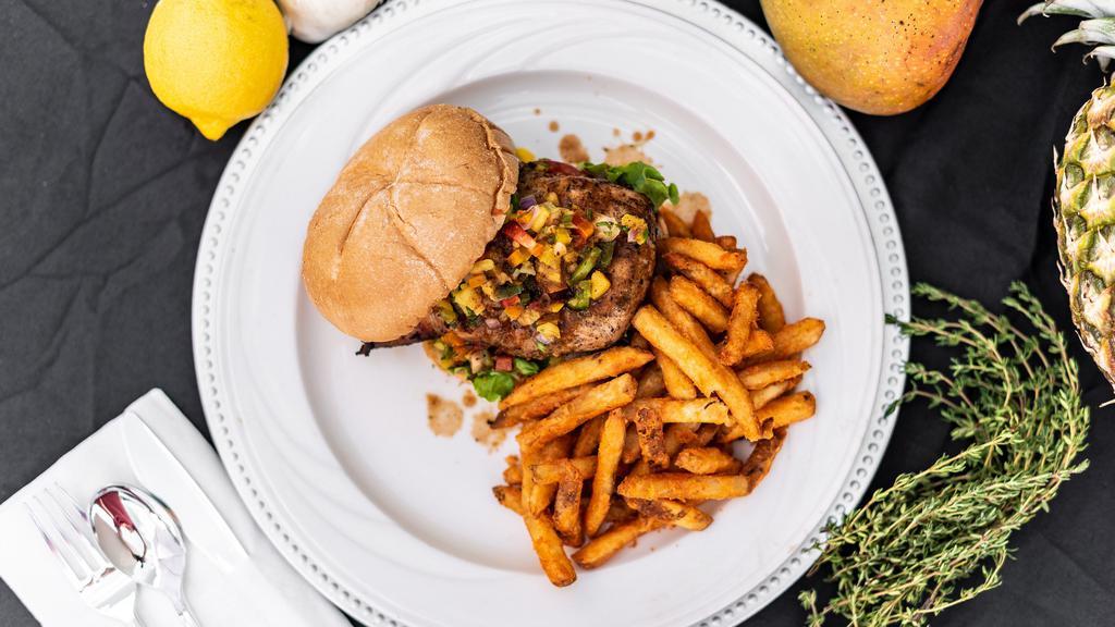 Jerk Chicken Sandwich · Jerk chicken breast on a brioche bun with lettuce, tomatoes, and our homemade mango pineapple salsa all with a side of seasoned fries.