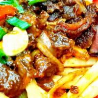 Oxtails And Fries  · Jamaican style oxtails over a bed of seasoned french fries.