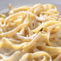 Fettuccine Alfredo · Wide pasta tossed with triple cream, butter and freshly grated Parmigiano cheese
