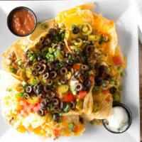 Over The Top Nachos · Fresh tortilla chips covered with our house made queso, diced tomatoes, black olives, green ...