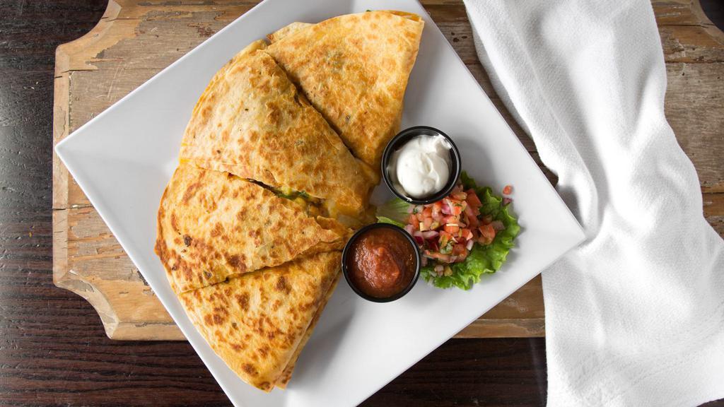 Veggie Quesadilla · Vegetarian. Two jalapeno cheddar tortillas loaded with shredded cheddar jack cheese, onions, peppers, corn, chopped chipotle black bean burger and diced jalapeños. Served with pico de gallo, sour cream and house made salsa.