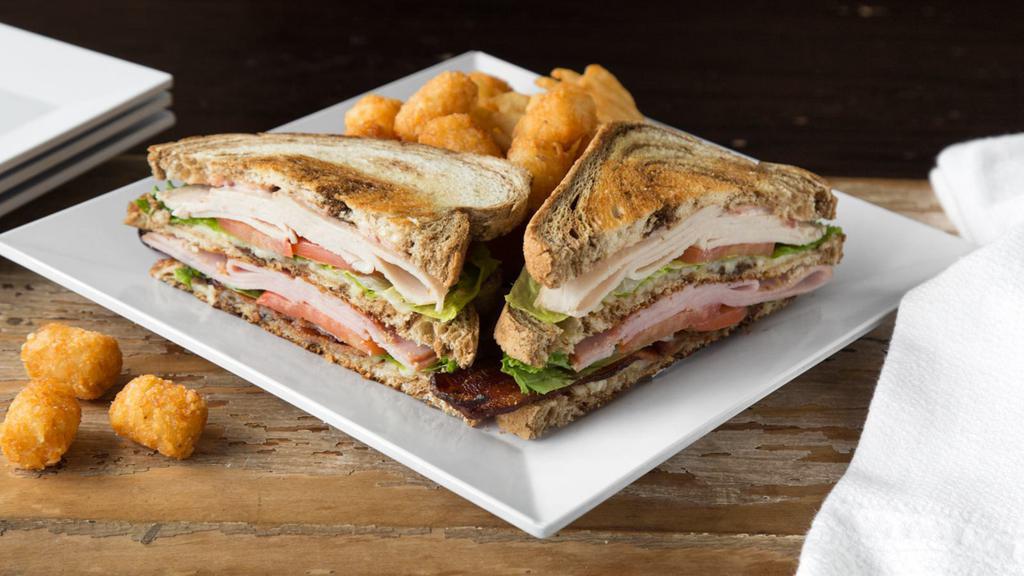3 Way Club · This triple decker delight will charm the taste buds. Toasted marbled rye piled high with smoked ham, turkey, white cheddar, crispy bacon, lettuce, tomato and cranberry mayo.