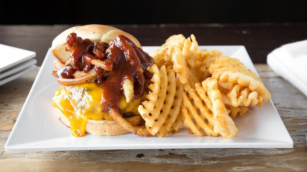 Roadhouse Burger · Topped with cheddar cheese, Texas toothpicks and our spicy Jack Daniel's bbq sauce.
