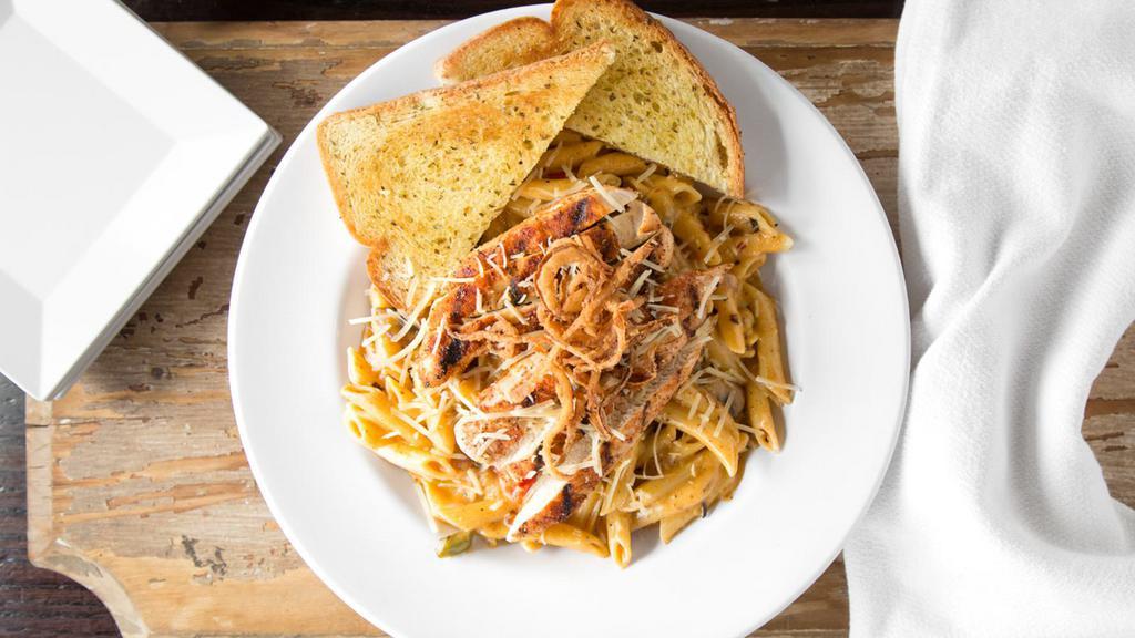 Cajun Louisiana Pasta · Cajun grilled chicken over penne pasta tossed with Cajun alfredo sauce, sautéed onions, mushrooms and bell peppers. Topped with our house Texas toothpicks and served with Italian garlic toast.