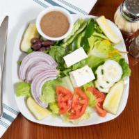 Greek Salad · Crisp romaine lettuce topped with tomato, cucumber, green pepper, onion, Kalamata olives, pi...
