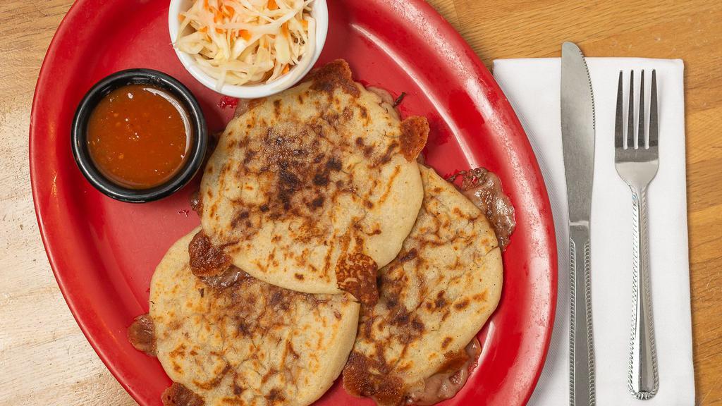 Pupusas (Each) · Corn tortillas filled with cheese and pork or beans and cheese or loroco and cheese or just cheese served with marinated cabbage and tomato sauce.