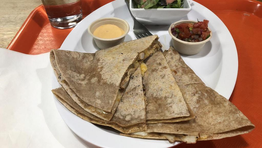 Quesadilla · Spicy. Chicken, veggie chorizo or spinach, whole wheat tortilla, mozzarella and cheddar cheese, homemade chipotle sauce, and pico de gallo. Served with choice of side.