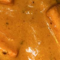 Butter Chicken · Tender morsels of chicken roasted in the clay oven and tossed in a rich creamy spiced tomato...
