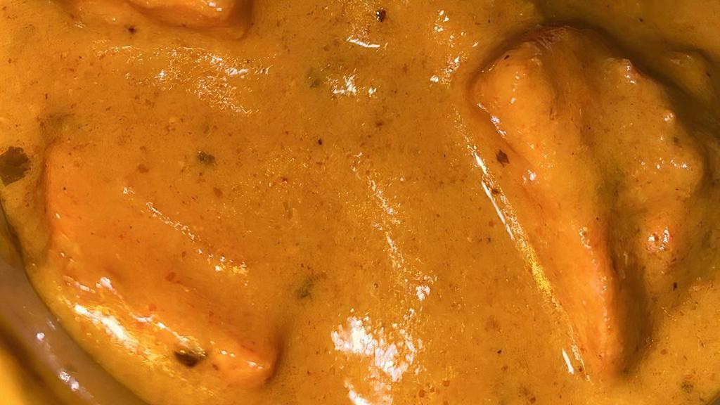 Butter Chicken · Tender morsels of chicken roasted in the clay oven and tossed in a rich creamy spiced tomato sauce.