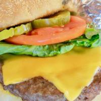 Champs Traditional Burger · Topped with choice of cheese, lettuce, tomato and pickles. With choice of one side and coles...