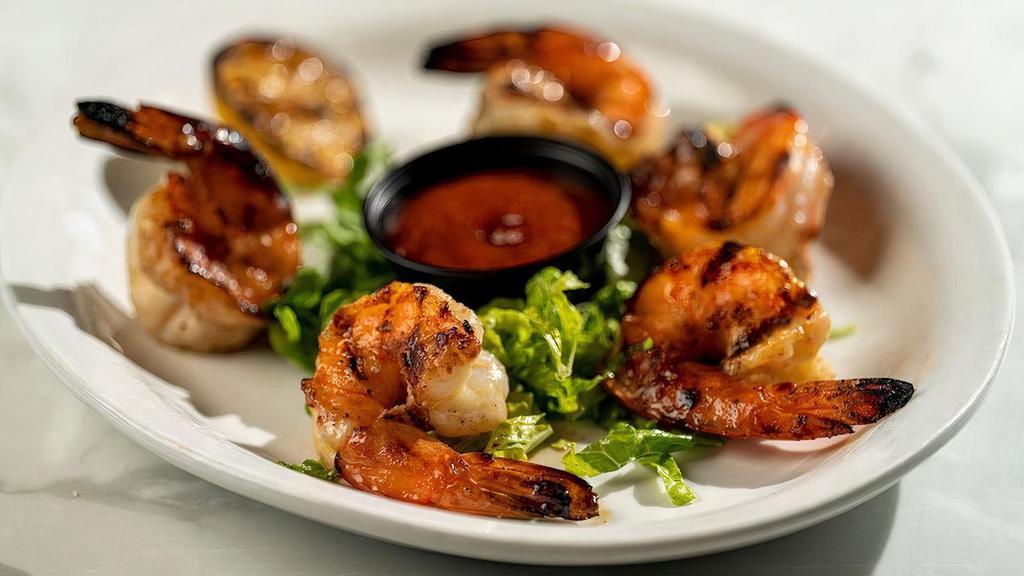 Grilled & Chilled Shrimp · Jumbo shrimp are seasoned, chargrilled and chilled. Served with our housemade cocktail sauce and grilled lemon.