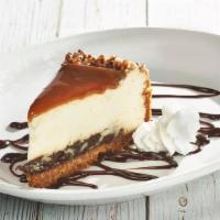 Turtle Cheesecake · A New York-style cheesecake over a thick layer of fudge, topped with caramel sauce and toast...
