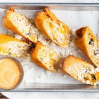Waldo Rolls · Flour tortillas stuffed with shredded cheddar and pepper jack cheese grilled chicken and bla...