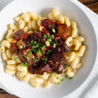 Kc Mac & Cheese · Pepper Jack queso tossed into our pasta with bbq burnt ends and topped with green onion.