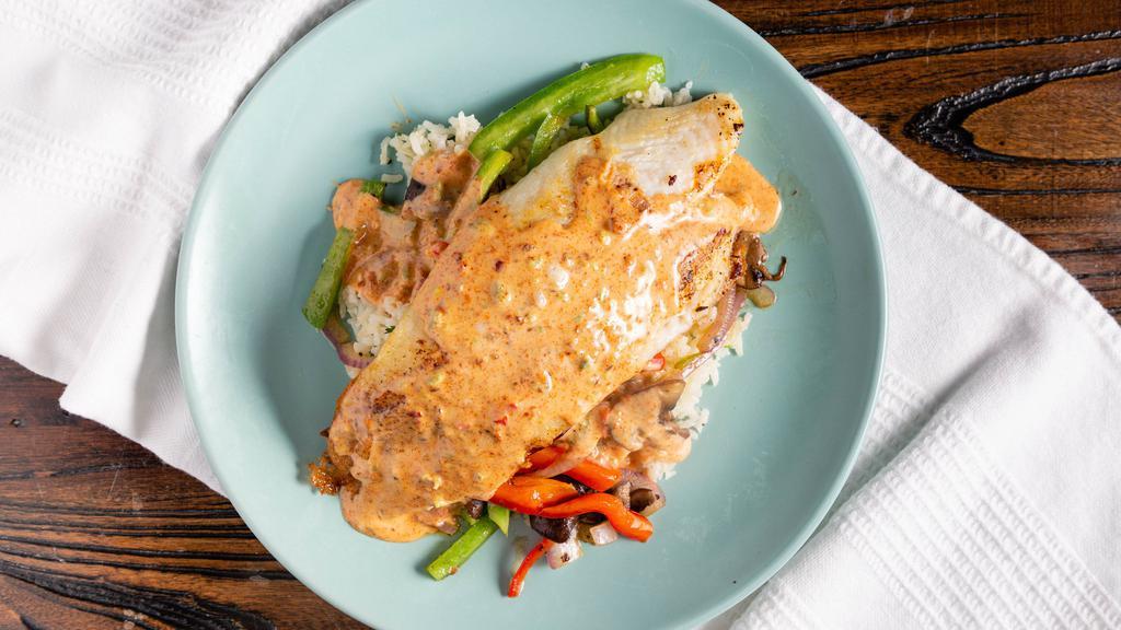 Northeast Blackened Fish · With fish with cilantro lime rice and seasonal veggies topped with a spicy ranch.
