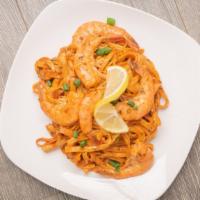Cajun Pasta · Fettuccine noodles wrapped in homemade Cajun pasta sauce, topped with spices, and green onio...