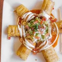 Chicken Taquitos · Crispy corn or flour tortillas filled with shredded chicken and cheese. Garnished with tomat...