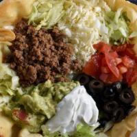 Taco Salad · A crispy flour tortilla shell filled with ground beef or shredded chipotle chicken, beans, l...