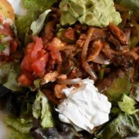 Fajita Salad · Crisp garden greens with fajita-style steak and chicken, bell peppers and onions. Topped off...