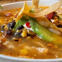 Sopa De Tortilla · A warm house mad chicken broth infused with an array of dried chiles and simmered with pulle...
