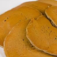 Buckwheat Pancakes · Homemade buckwheat pancakes served with whipped butter and warm maple syrup.