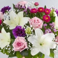 Glorious Jewels Bouquet · All-around arrangement with pink roses, purple carnations, white Asiatic lilies, hot pink Ma...