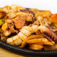 Spicy Squid Wok-Fry · Wok-fried spicy squid with vegetables and rice cake. Served with side dishes and rice.