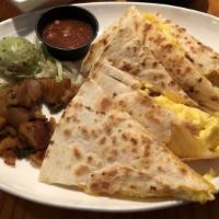 Coyote Quesadilla · Flour tortilla stuffed with bacon, eggs and cheese. Served with coyote potatoes, guacamole a...