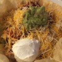 Tucson Taco Salad · Crispy flour tortilla topped with refried beans, pulled seasoned chicken, shredded lettuce, ...