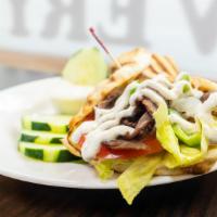 Beef Gyro Sandwich · Thinly sliced beef, peppers, sautéed onions, roasted peppers, creamy tzatziki sauce, and ser...