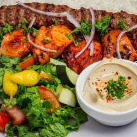 Combo Kabob · Chicken breast and beef lula served with hummus, rice, salad, onion, and pita bread.