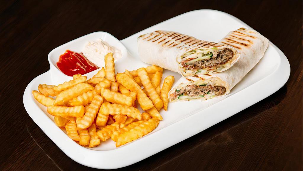 Chicken Shawarma Wrap · Your choice of shawarma meat, hummus, tahini sauce, onions, pickles, tomato and cucumber, served with a side of French fries and a side of tahini sauce.