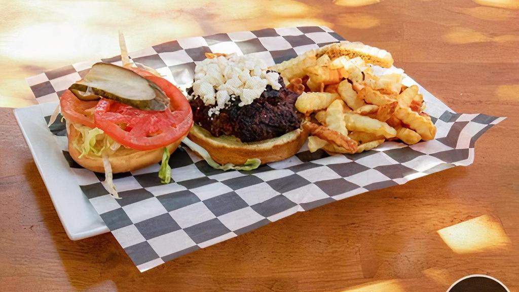 Greek Burger · seasoned ground beef topped with lettuce, tomatoes,  pickles, feta cheese, onions, and tzatziki sauce.