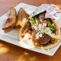 Gyro Sandwich · Beef and lamb gyro shaved in a pita with lettuce, tomatoes, onions, parsley, feta cheese, an...