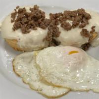 Biscuits N Gravy · 2 flakey biscuits smothered country gravy with sausage and 2 eggs.
