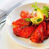 Tandori Chicken Wings · Marinated chicken wings barbecued and served with mint and yogurt sauce.