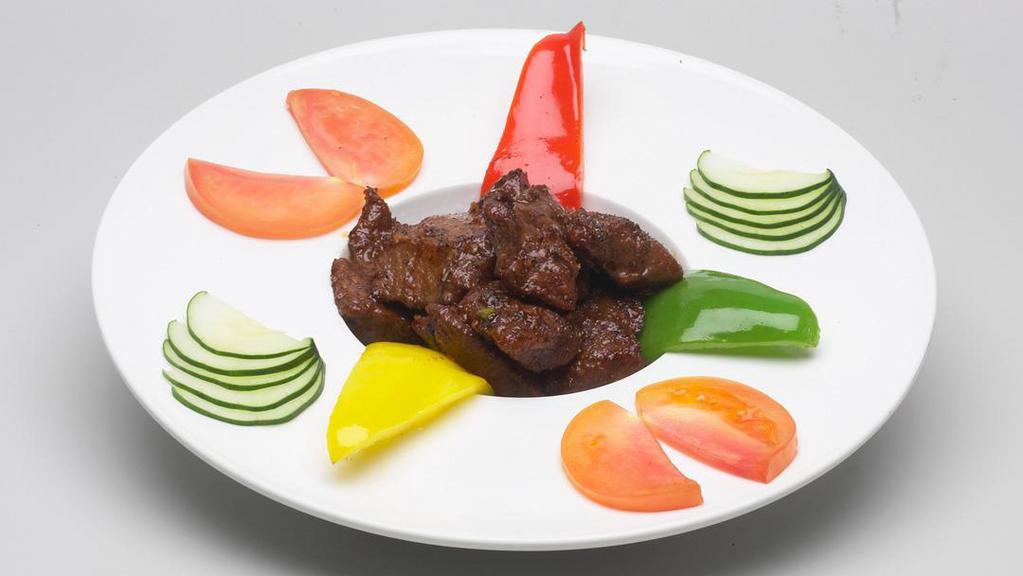 Pepper Steak (Beef Loc Lac) · Stir Fried Tenderloin Steak with Fresh Garlic, Lime Juice, Black Pepper, Served Vietnamese Style with Cucumber, Red Peppers, and Tomato
