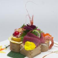 Chirashi Sushi · Raw or undercooked. Assorted fillets of raw fish vegetable and tamago (egg), served on a bed...