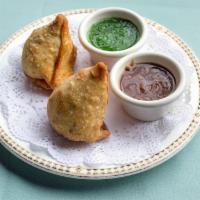 Vegetable Samosas · Two deep fried pastries stuffed with mildy spiced potatoes and peas.