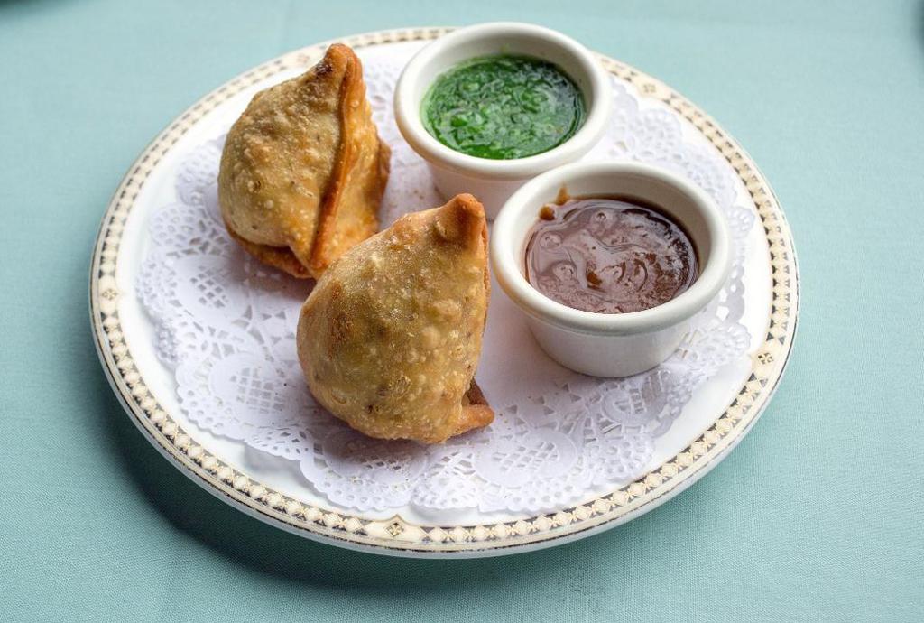 Vegetable Samosas · Two deep fried pastries stuffed with mildy spiced potatoes and peas.