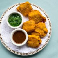 Paneer Pakoras · Pieces of paneer, dipped in spiced chickpea batter and deep fried.