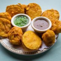 Vegetable Pakoras · Cauliflower and potatoes dipped in chickpea batter and deep fried.