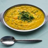 Yellow Dal Tadka · Cooked split lentils, tempered with cumin, ginger, garlic, and onions.