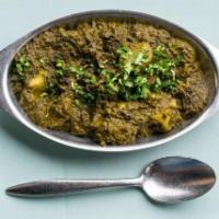 Saag Aloo · Pieces of potatoes cooked in a suateed spinach with a touch of cream.
