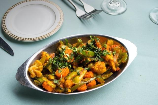 Vegetable Karahi · Mixed vegetables, stir fried with onions and bell peppers, blended into a light curry sauce.