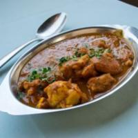Chicken Curry · A traditional, onion based gravy, blended with an array of spice.